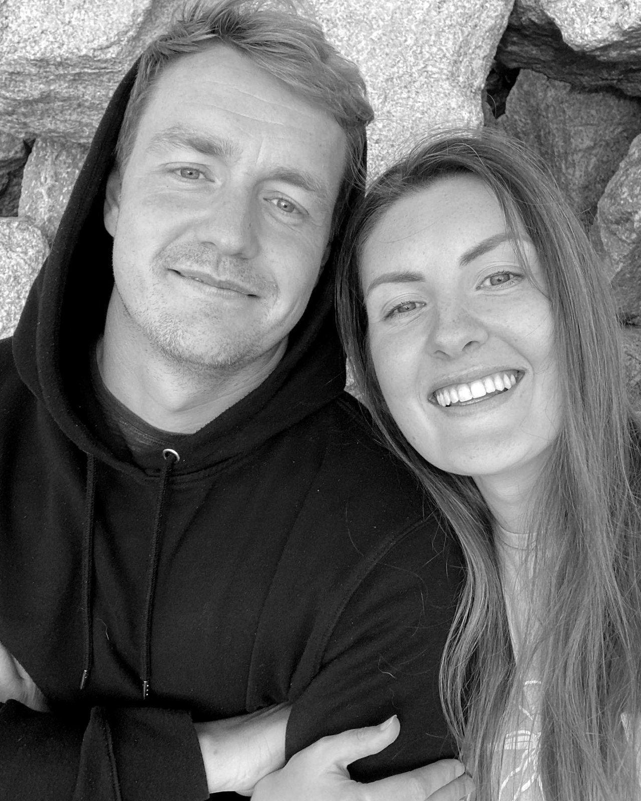 Kelly and Martin smiling together by the rocks
