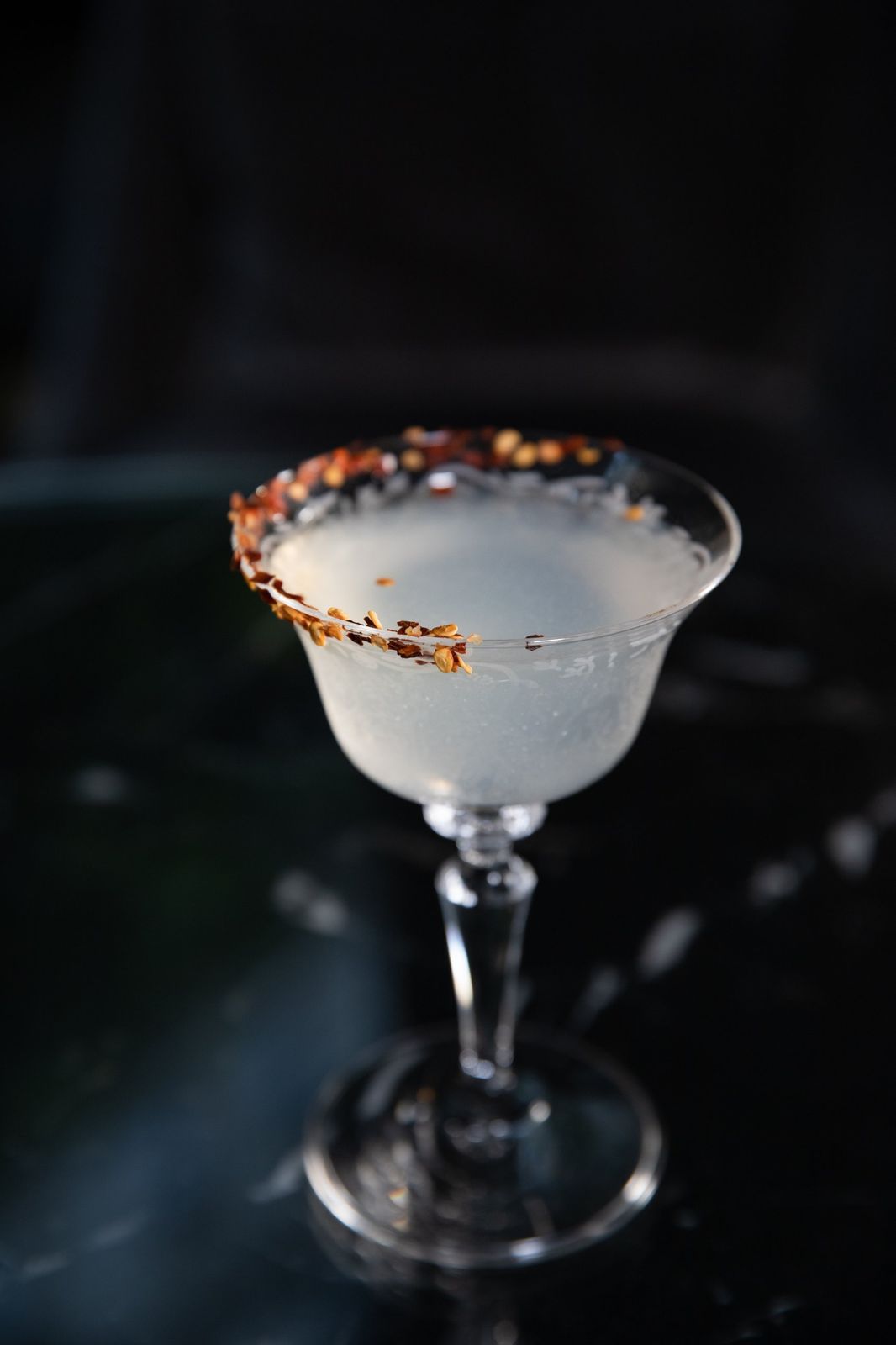 A cocktail with a chilli-flake rim