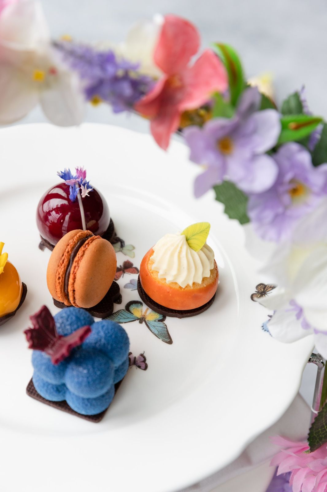 Colourful petit fours on a butterfly plate