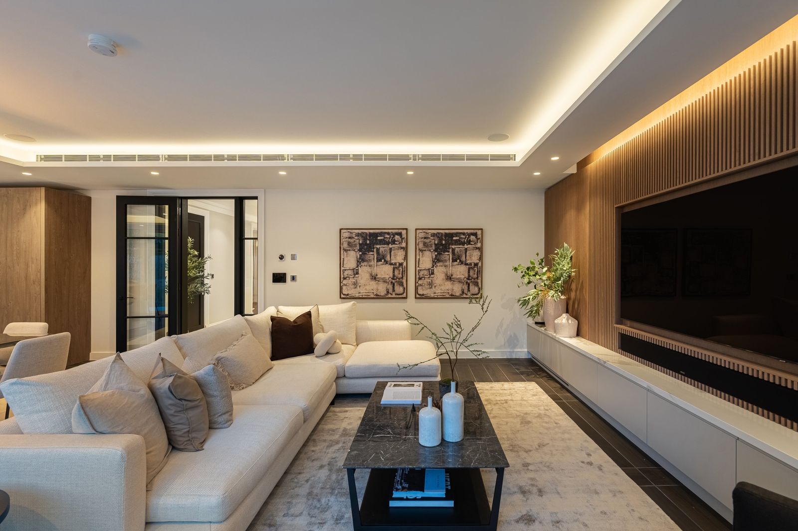 The living room with a slatted media wall