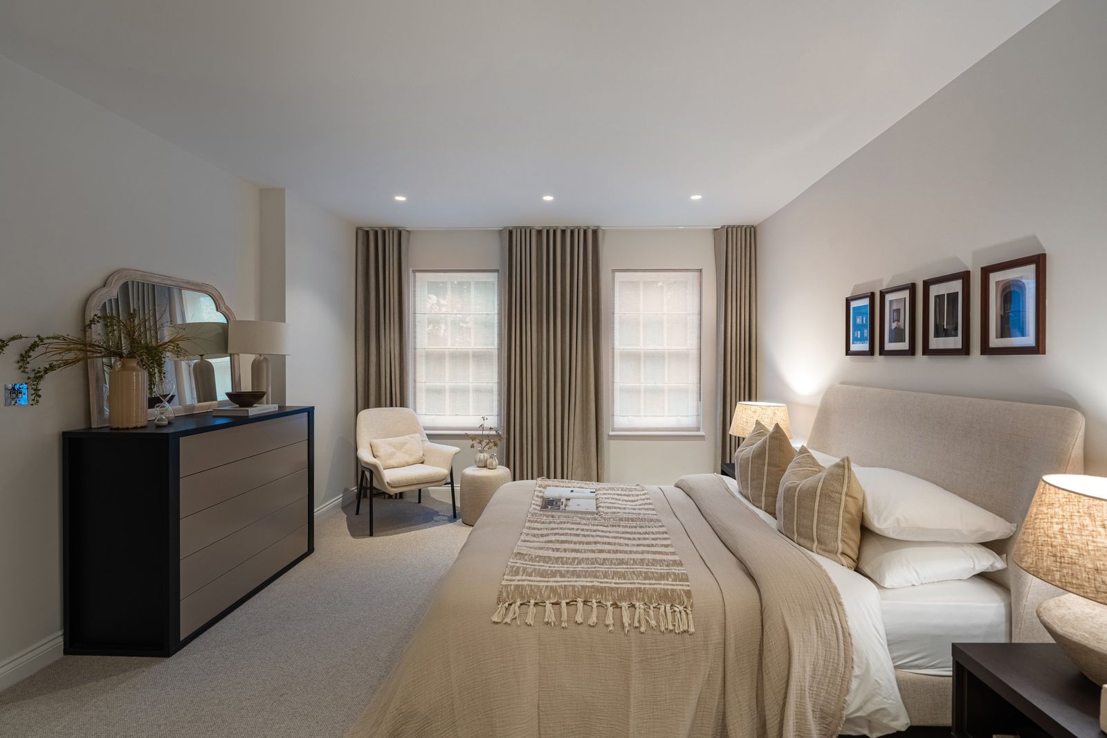 A guest bedroom with two sash windows