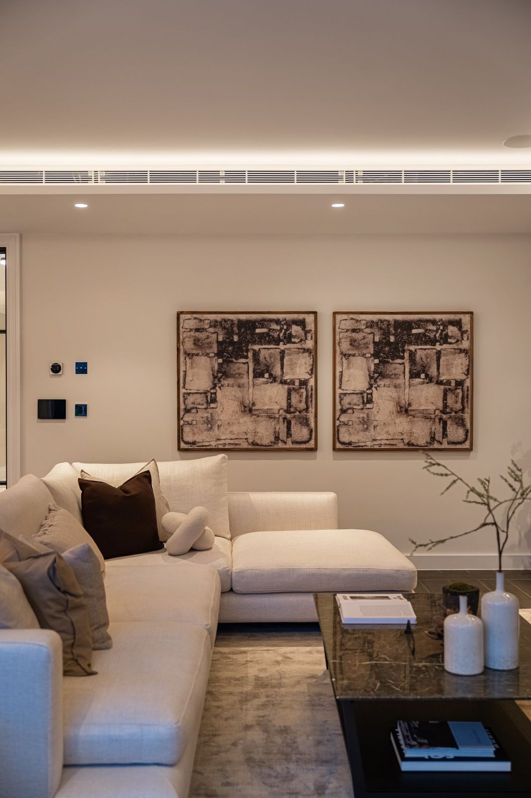 A tidy living room with a styled sofa and artwork