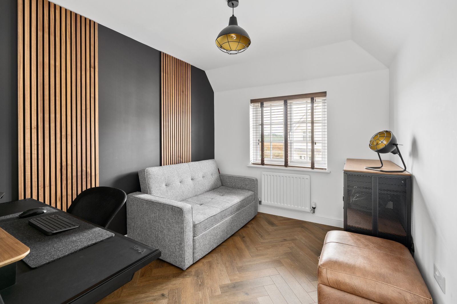 The study with a slatted feature wall and sofa