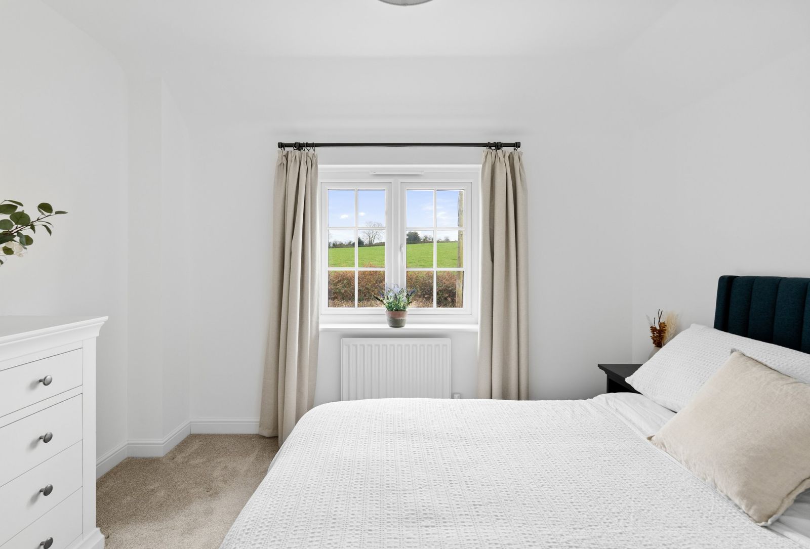 The bedroom window framing the fields