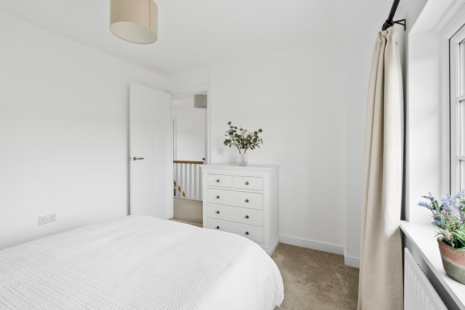 The bedroom chest of drawers and door to the landing