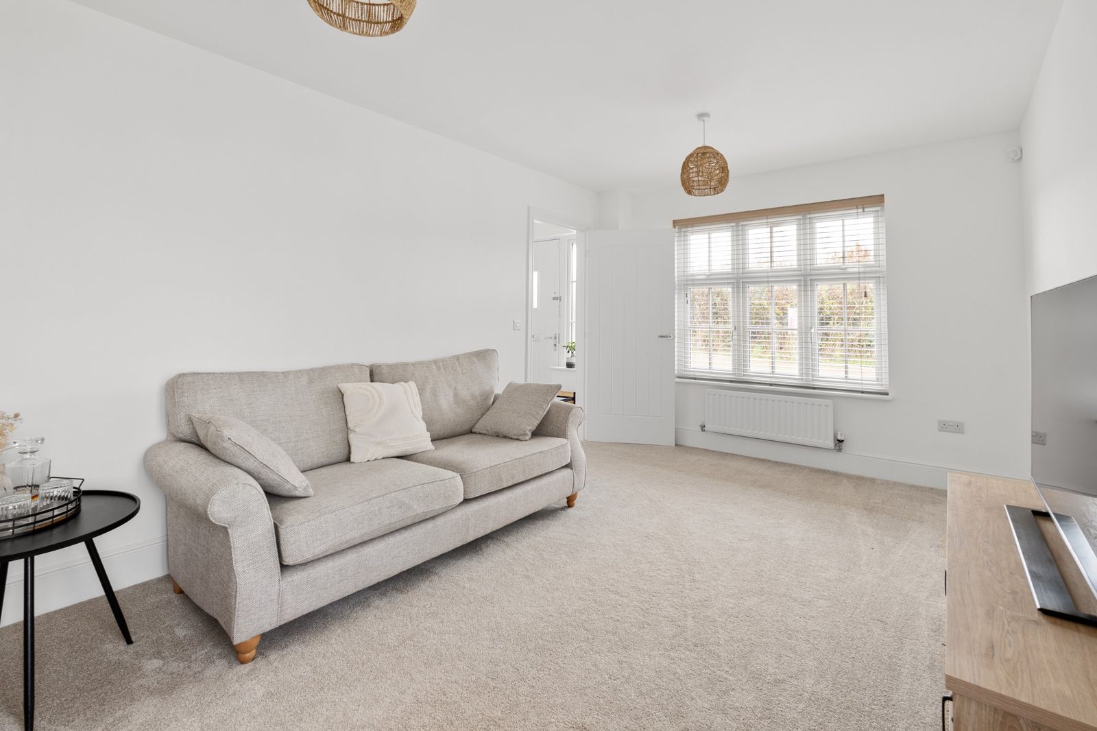 The living room sofa by the front window