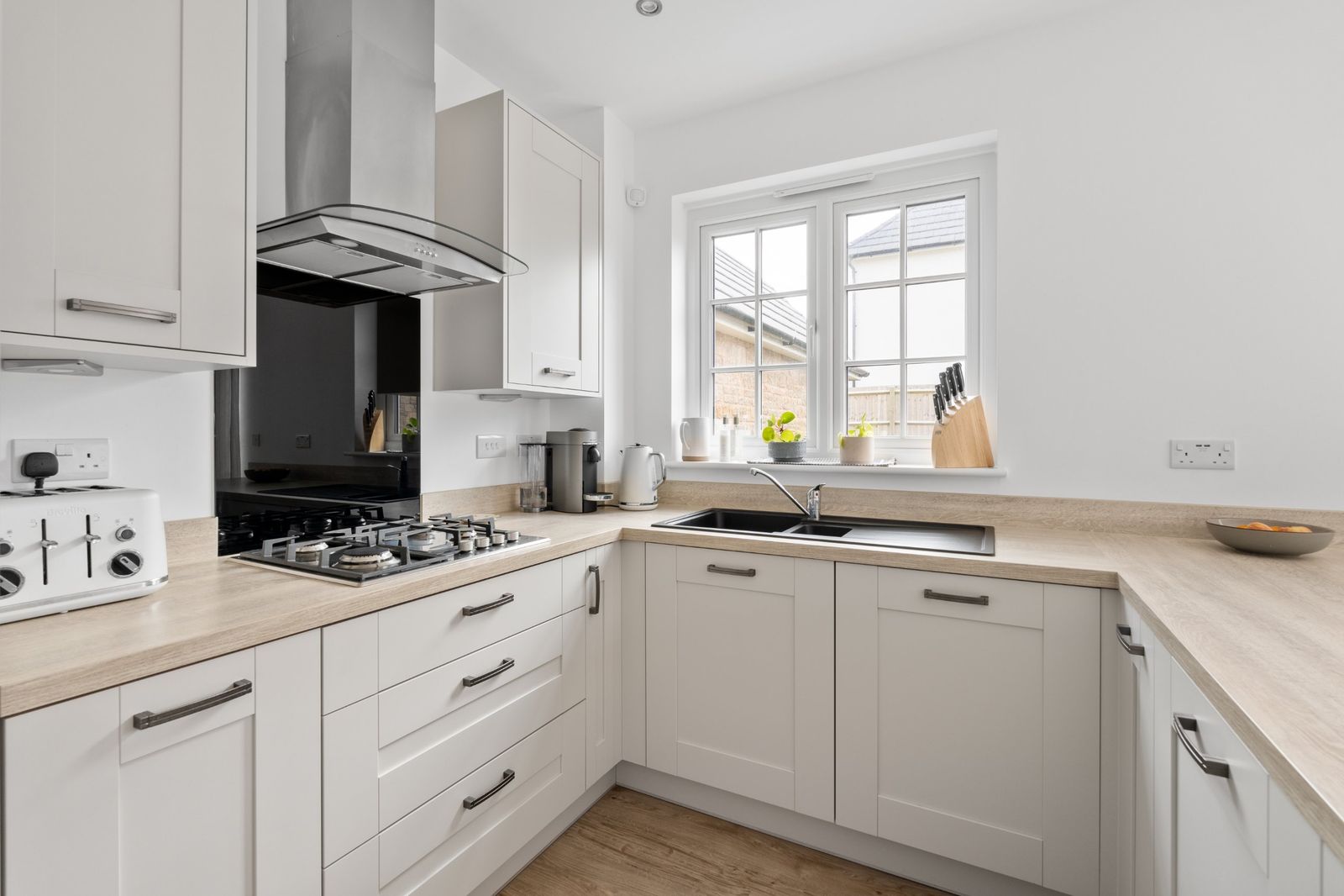 The kitchen sink and hob under the window