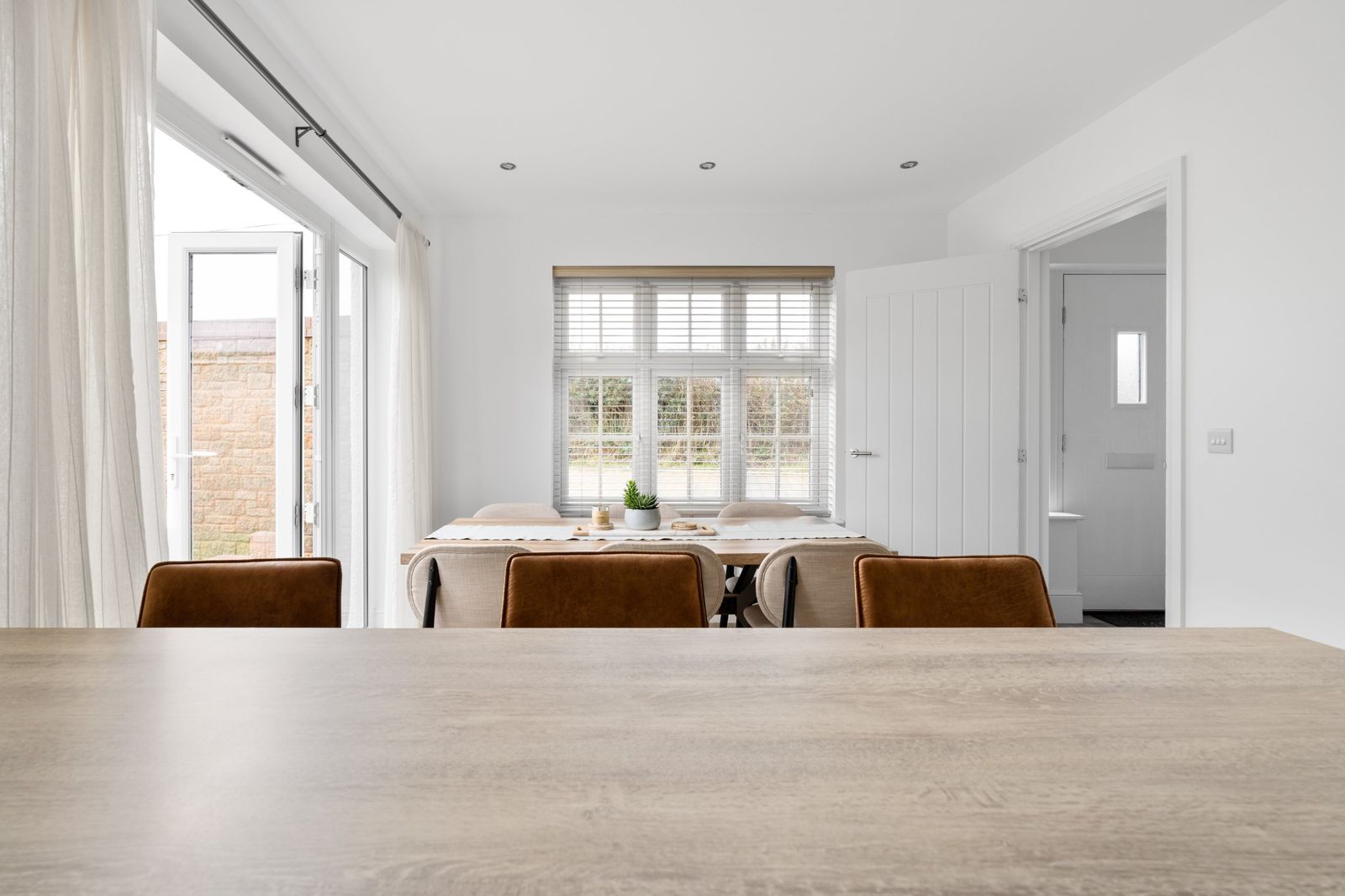 Looking across the breakfast bar to the dining table