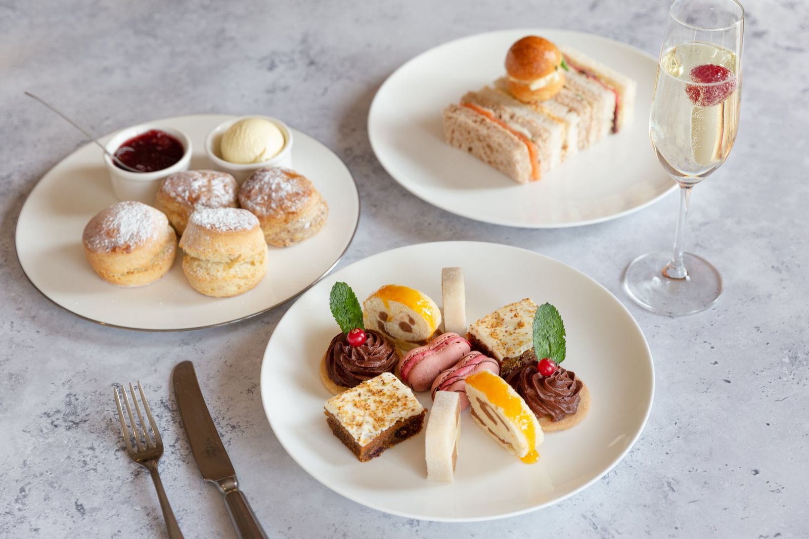 Afternoon tea with scones, cakes, sandwiches and a glass of fizz