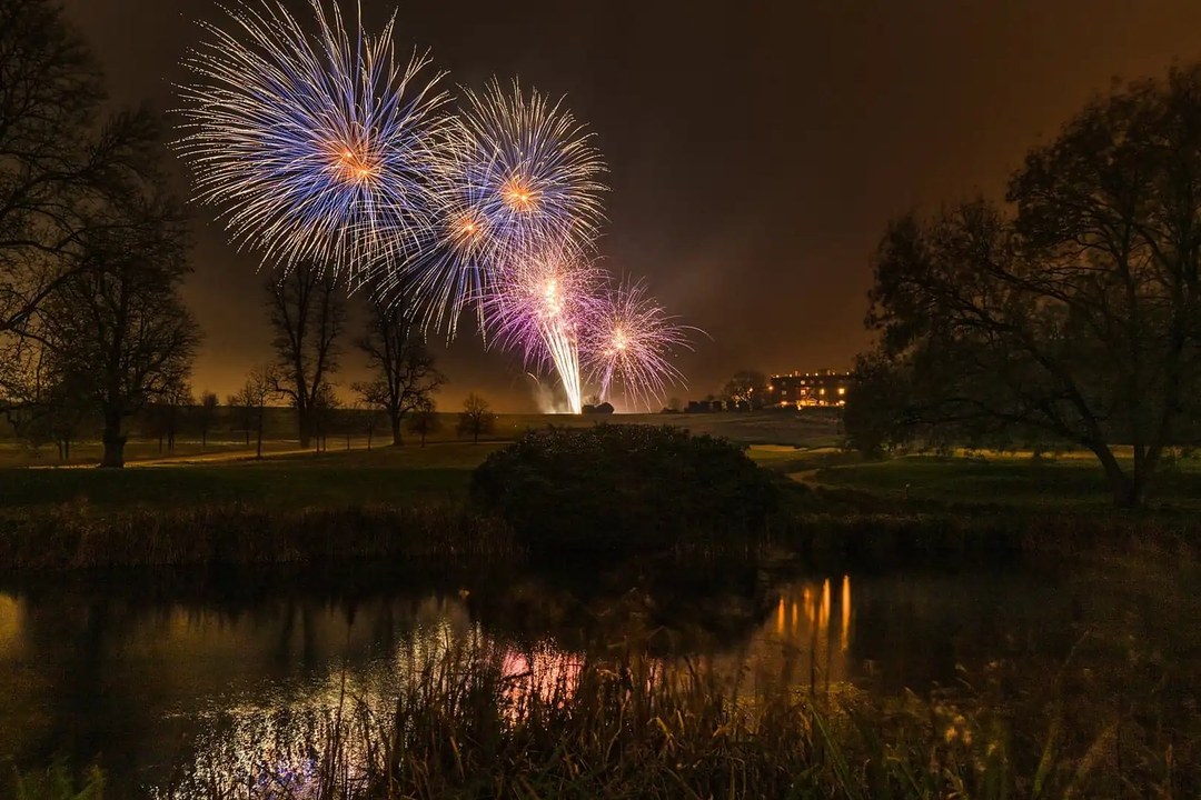 Fireworks over the grounds and lake at night