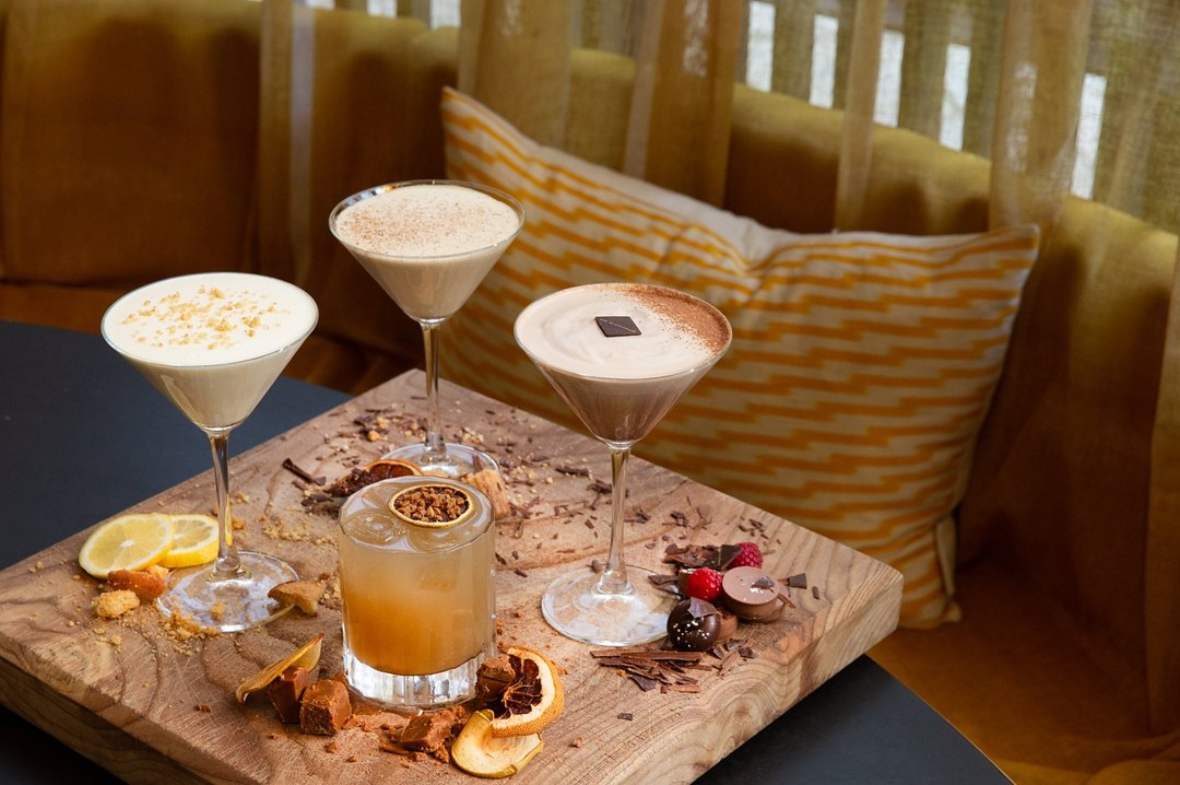 Four autumn cocktails on a wooden board