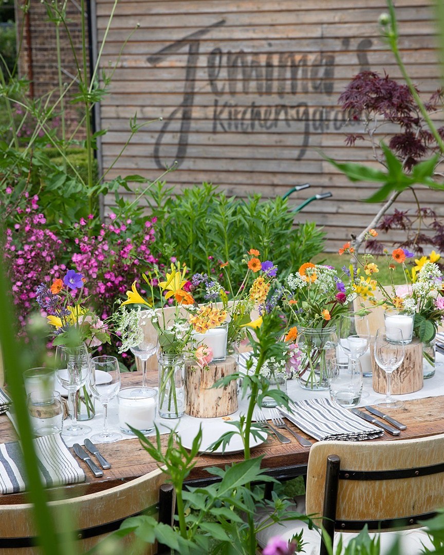 A table set with wildflowers in the kitchen garden