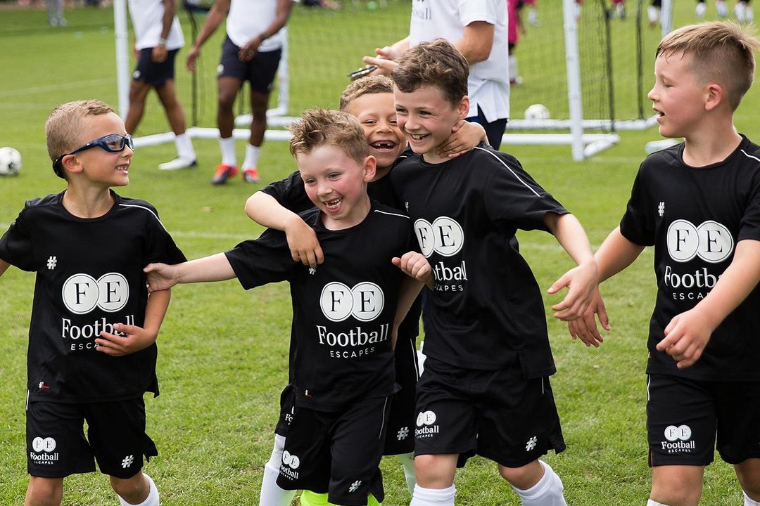 Young footballers celebrating at a football camp