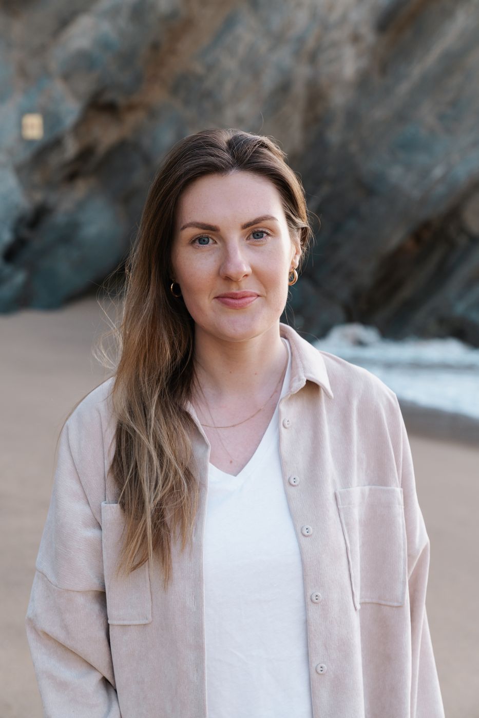 Kelly, photographer at Shoreline Bay Studios, on a beach in Cornwall