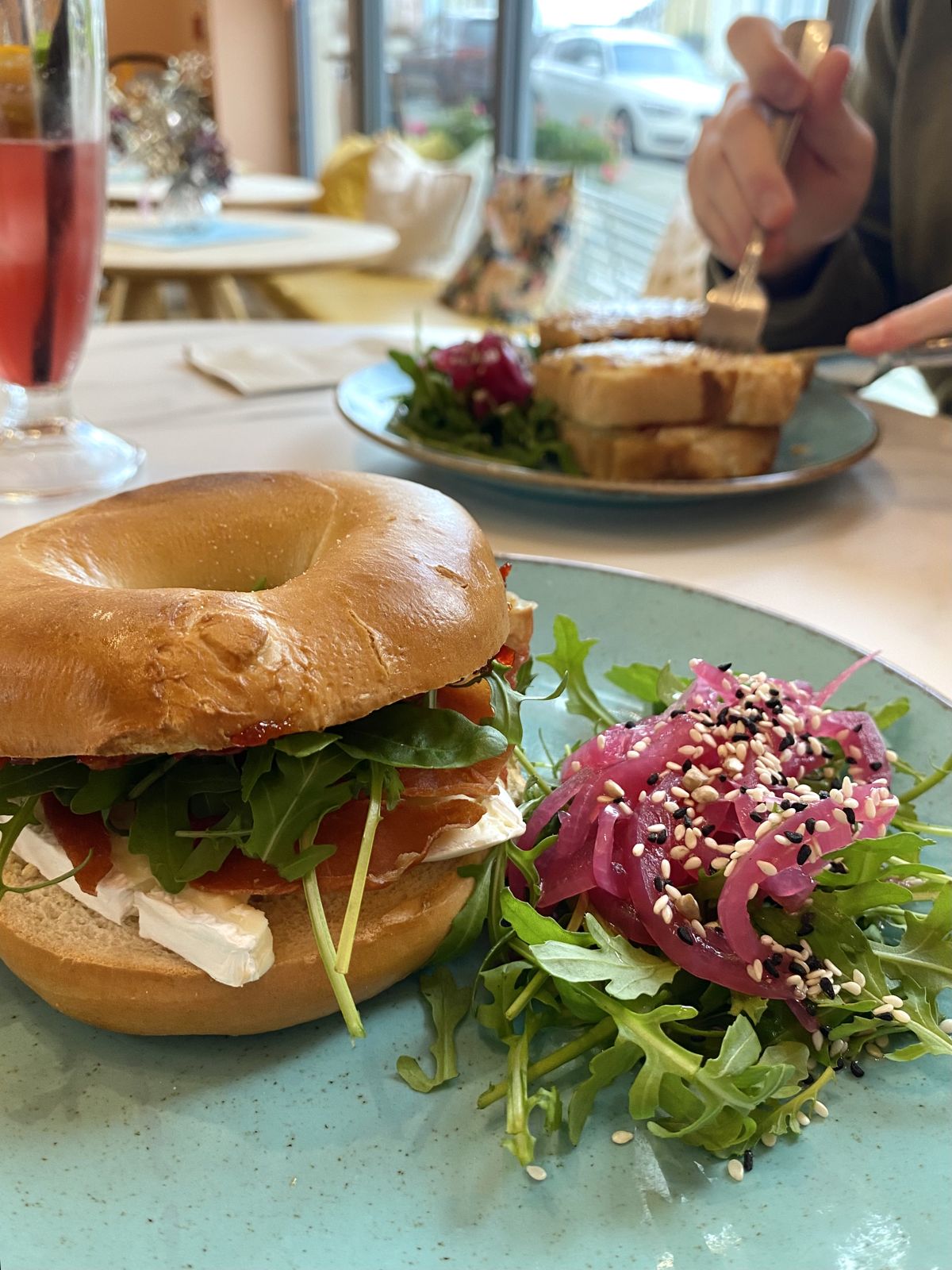 A bagel with salad and a pink drink at Ladyvale Bakery in Newquay