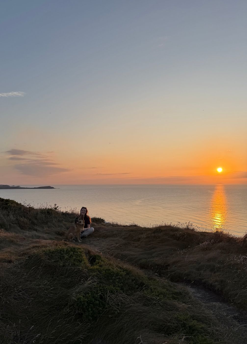 Kelly and Poppy on the clifftop at sunset