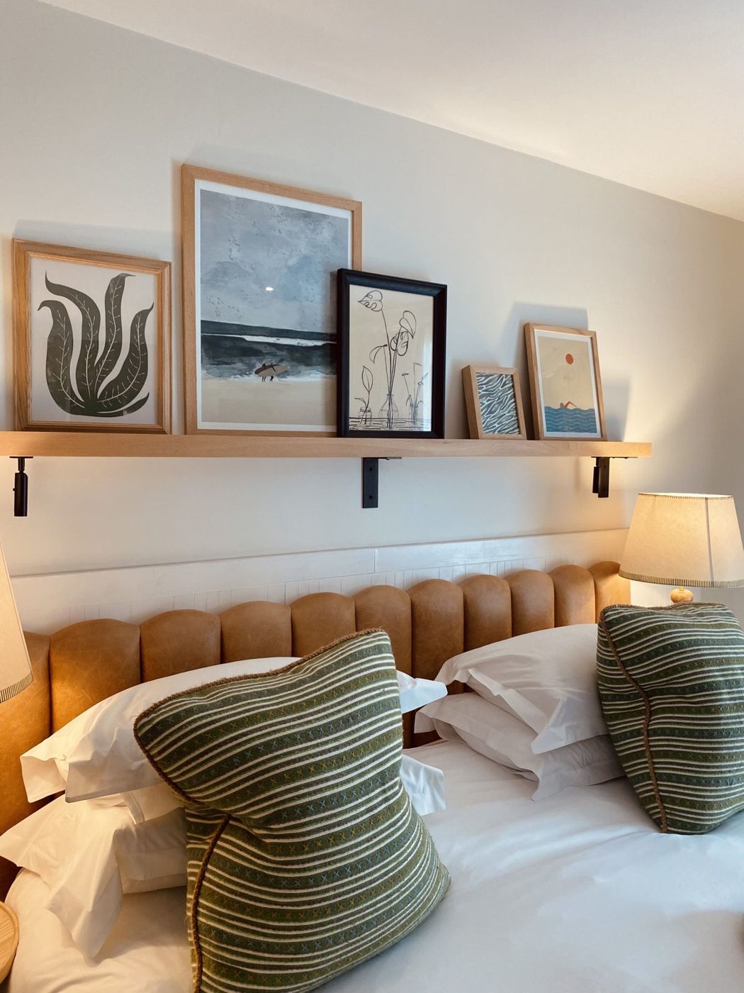 A hotel bedroom with coastal prints