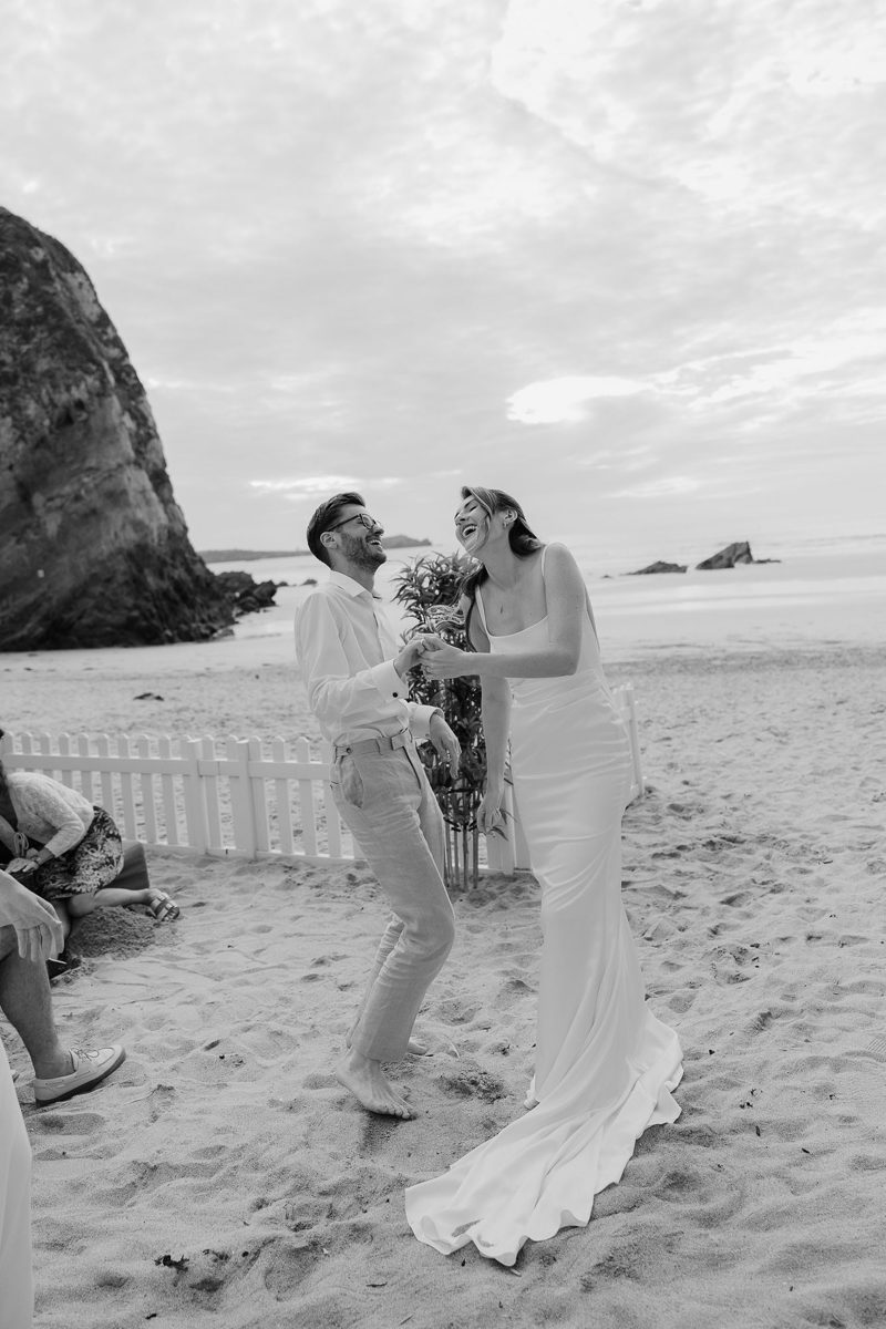 Guests laughing and dancing on the sand