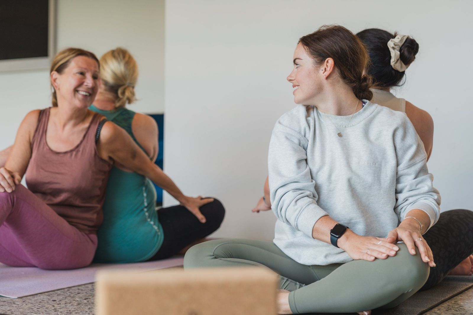 Guests smiling at each other during a seated twist