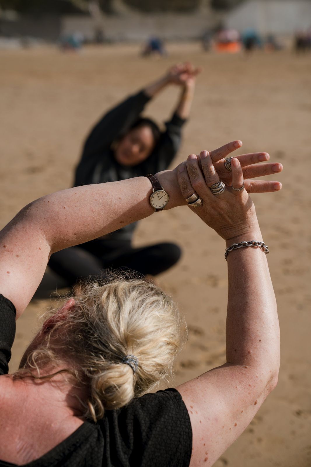 A guest stretching on the beach
