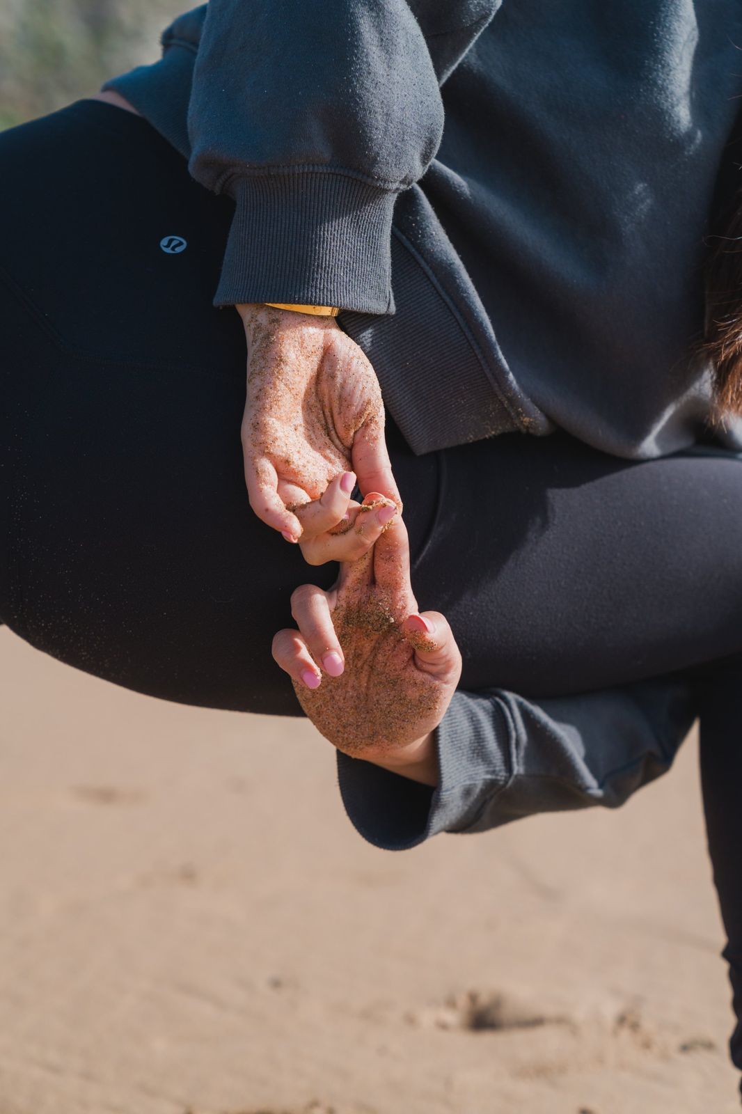 Sandy hands in a mudra on the beach