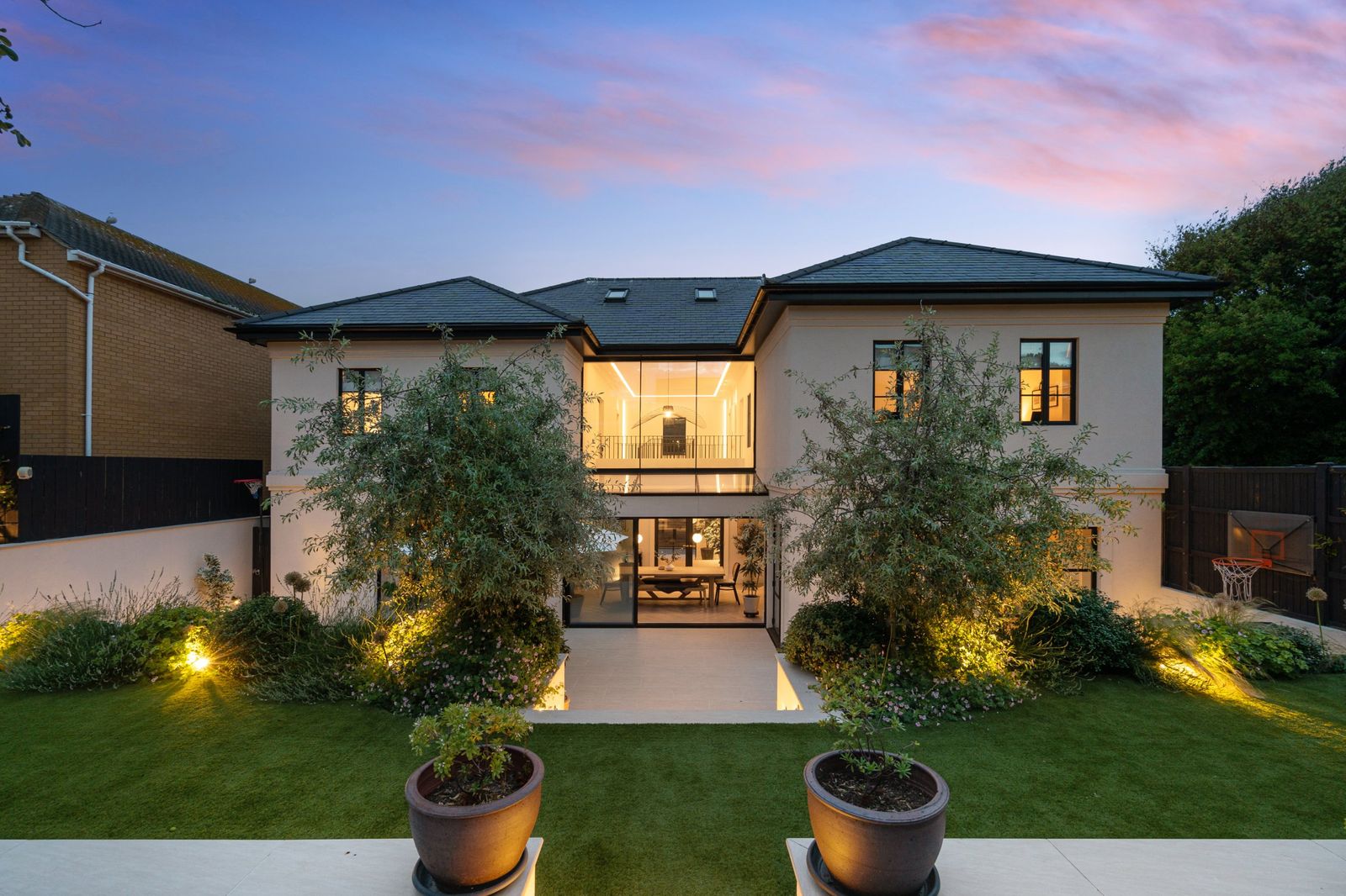 Southwinds lit up at dusk, seen from the garden