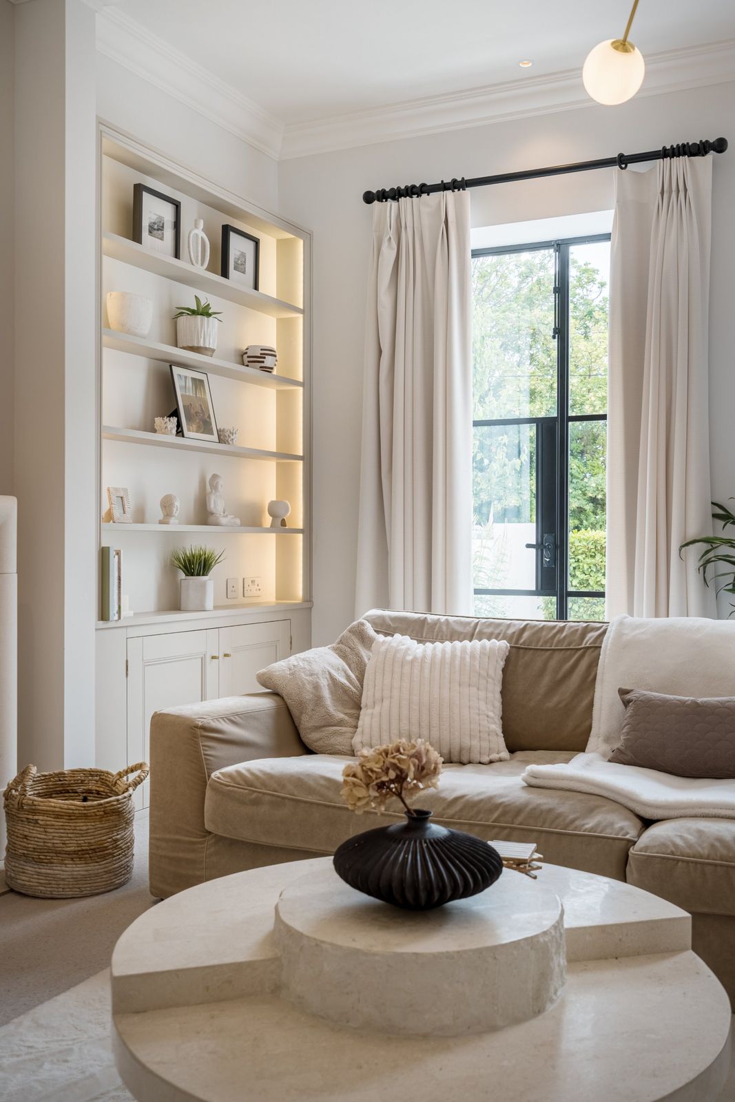Lit shelves beside a tall garden window