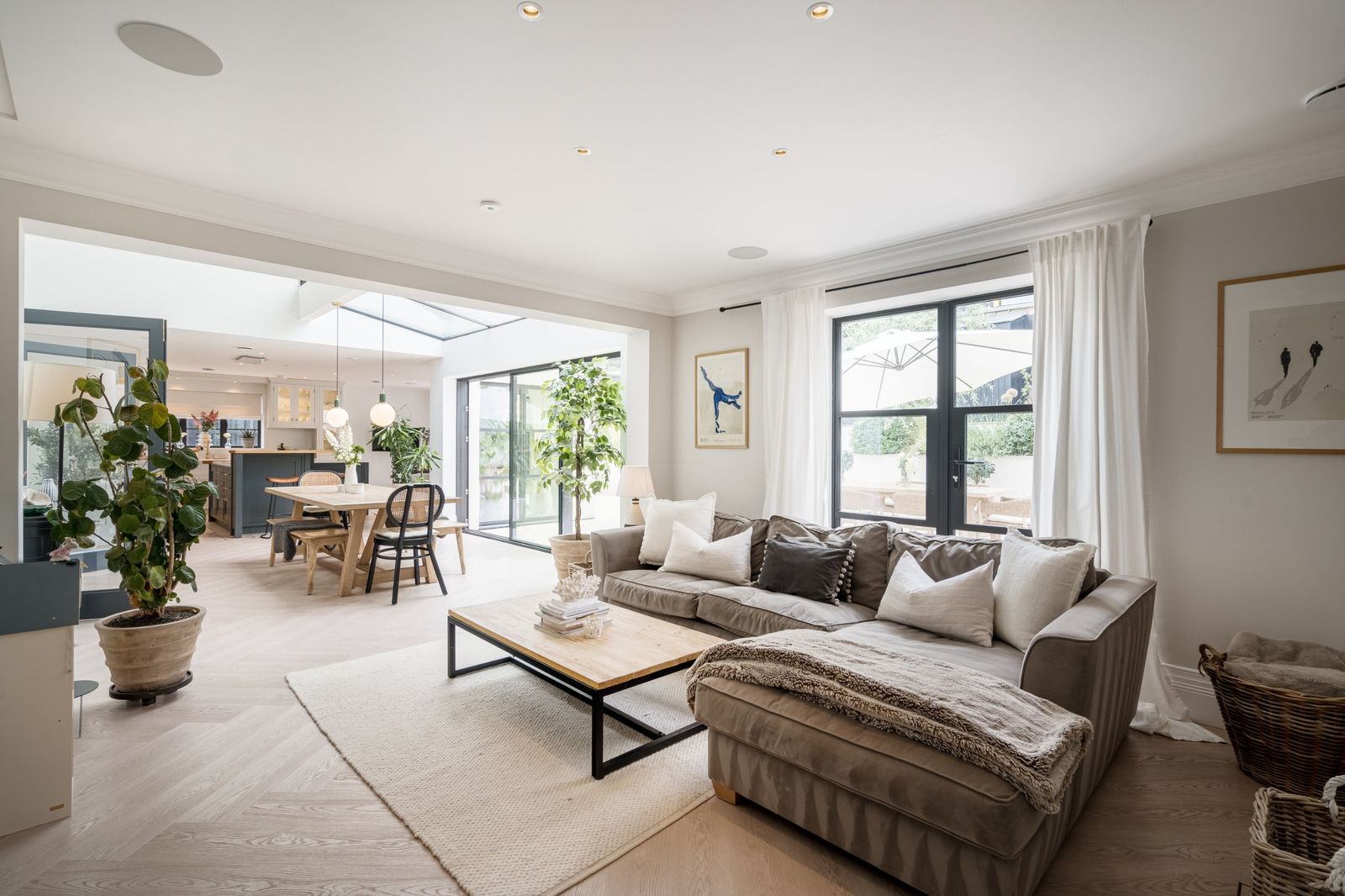 The open-plan living space leading to the kitchen and dining room