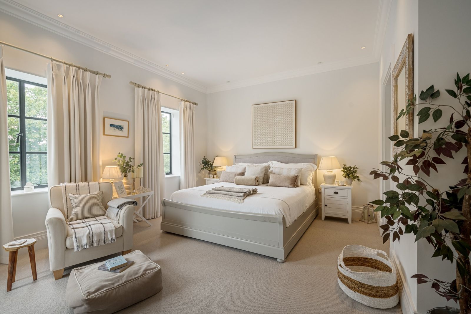 The main bedroom with a sleigh bed and reading chair