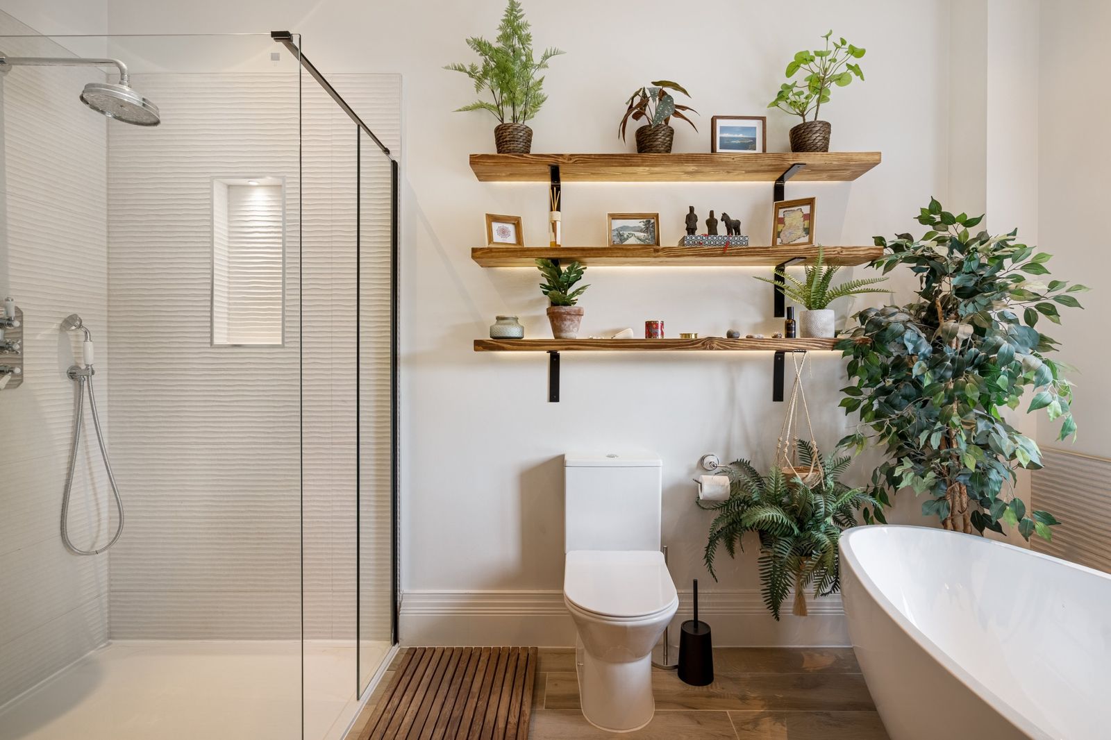The walk-in shower and lit shelves