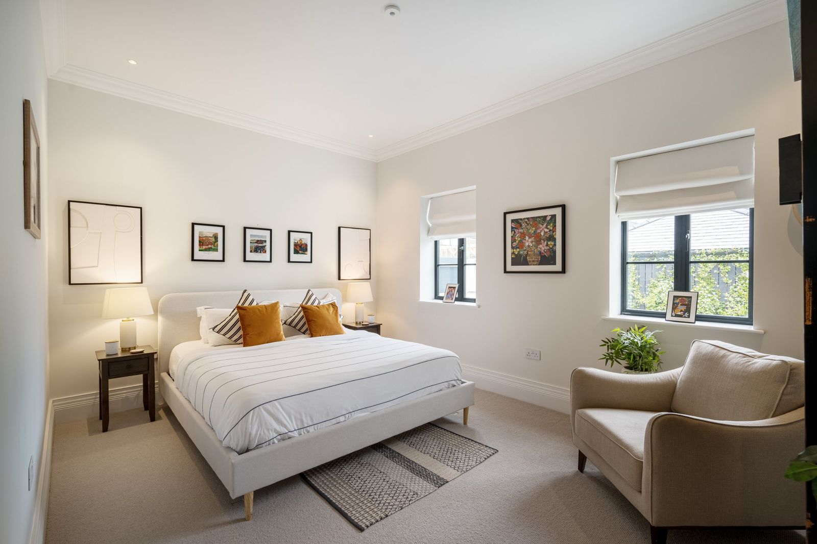 A guest bedroom with ochre cushions