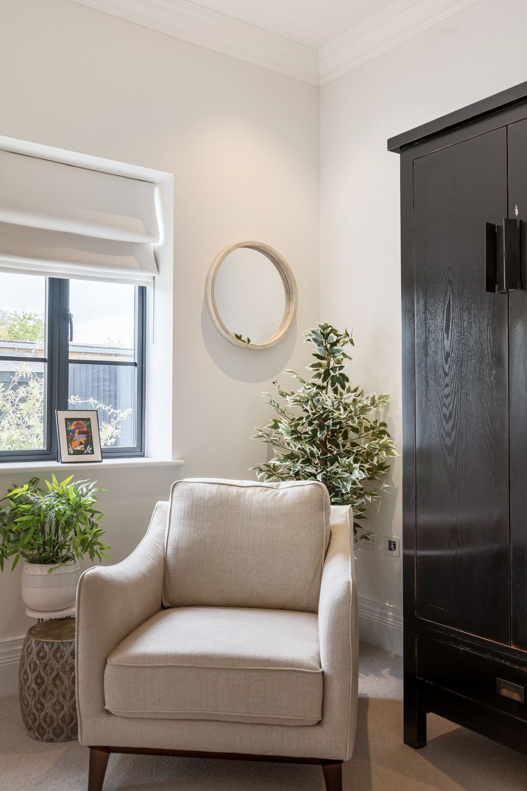 An armchair by the window in the guest bedroom