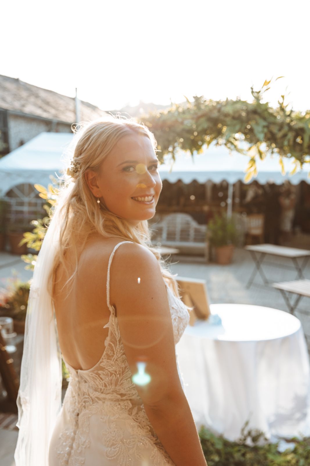 A smiling bride looking back over her shoulder